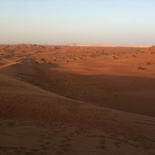 The hill sits beside a vast open desert view