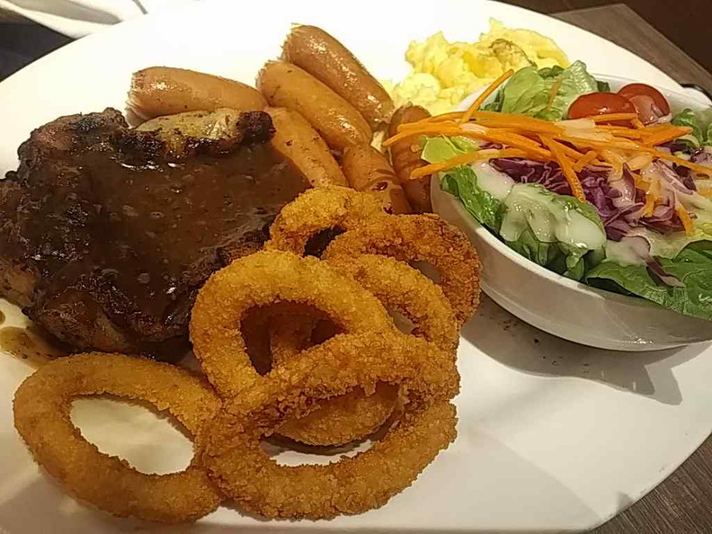 Steaks mixed grille with sausages, garden salad and onion rings