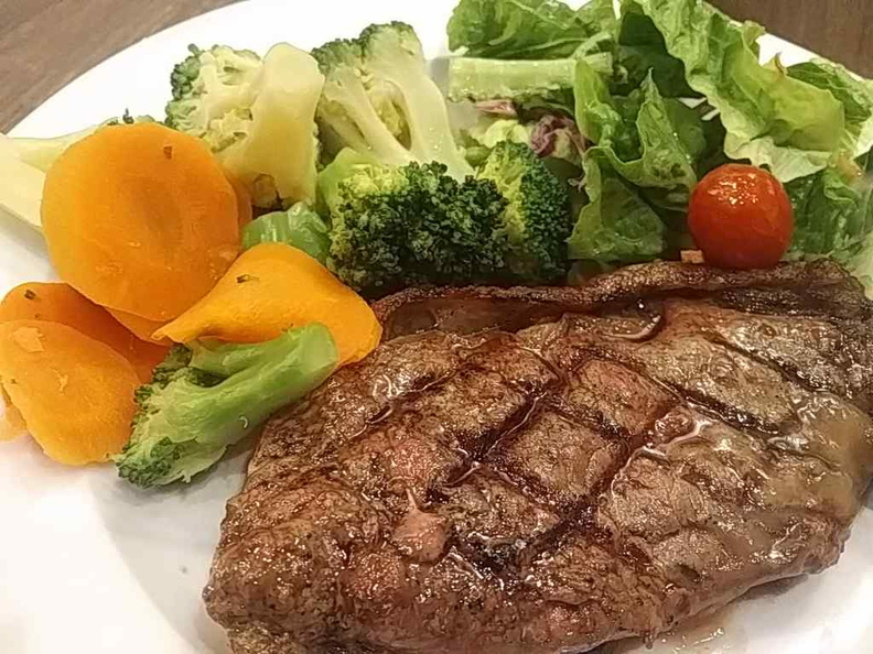 Their more premium steak, medium-rare done with country vegetable sand garden salad