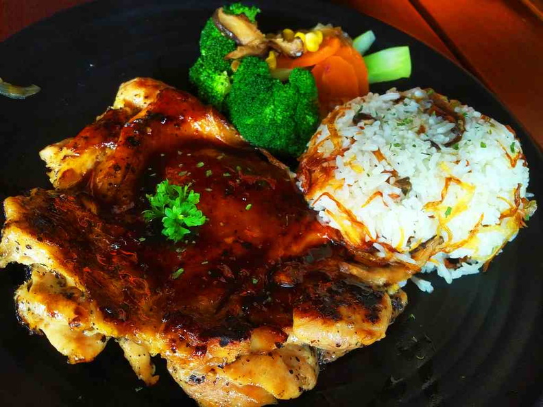 The Grilled chicken dish with rice and vegetable sides