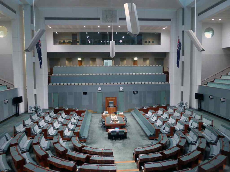 Overview of the House of Representatives. It has a very similar layout the Senate chamber, but in a muted hue of greenish-grey 