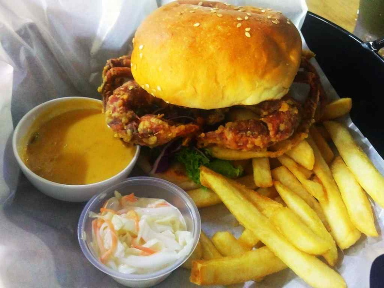 Their signature salted egg yolk soft shell crab burger. Served with fries and a water chestnut drink.