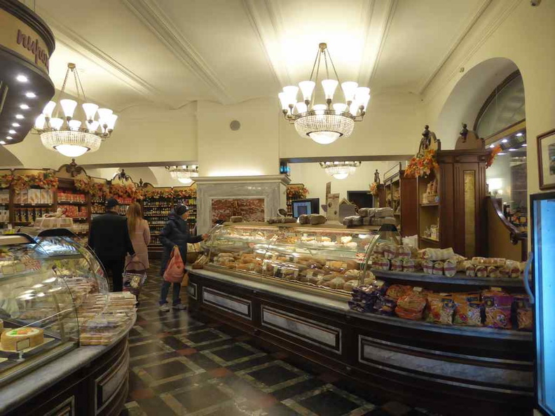 General supermarket ambience. It has an oldie look to it, complete with dark wood shelves, tiled flooring lit with topped chandeliers