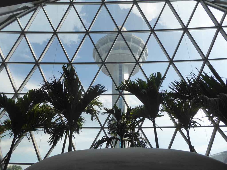 View of the Changi Airport central control tower looking through the Jewel glass panels