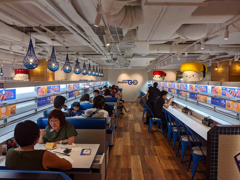Inside the Sushi-go restaurant. It has separate seating arrangement from the main &JOY food court