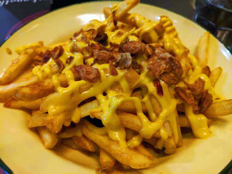 Filthy fries comprising of crispy caramelised onions, laced with cheese and bacon gravy