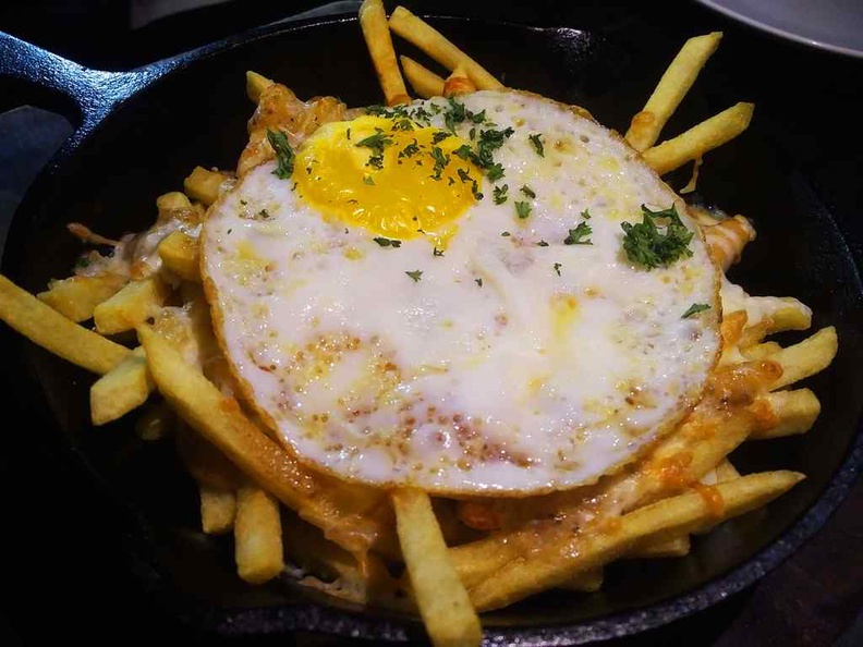 Beast southern kitchen poutine fries ($14) are doused with sausage gravy, mozzarella cheese and a sunny side up egg.