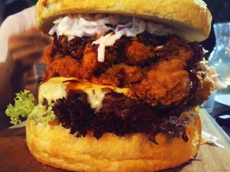 Layers of beef, pulled pork and fried chicken.