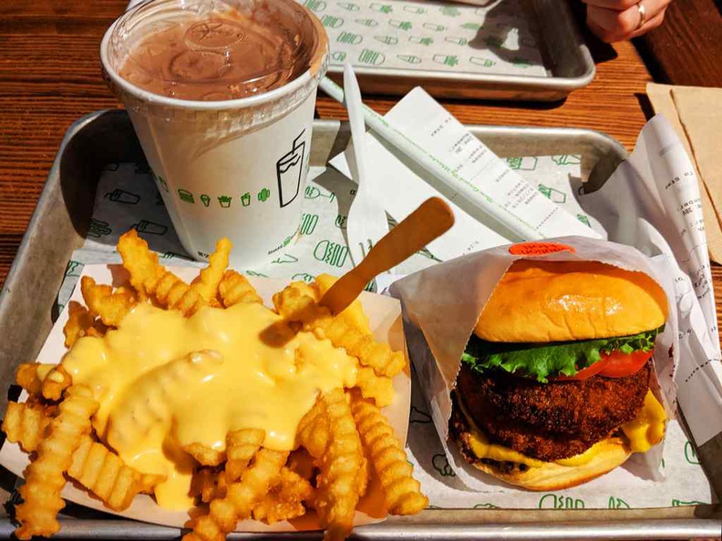 A StackShack meal with the works of cheese fries and creamy chocolate milkshakes.