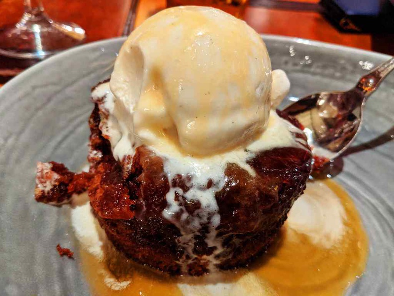 Sticky toffee pudding, a sweet contraption of vanilla on a warm heated chewy pudding base. It is a recommended dessert at the end of your meal