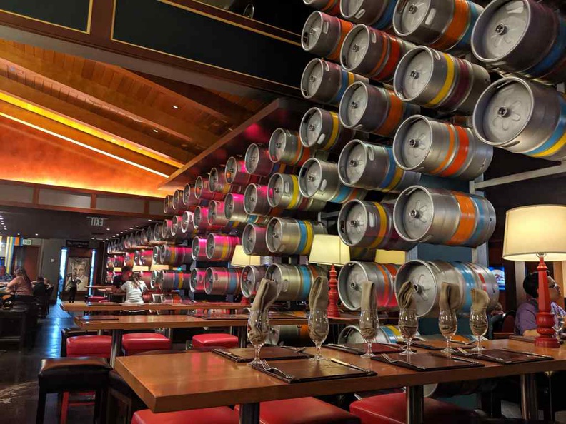 The restaurant interior is cool, modern, and peculiar, such as the wall of beer kegs by the dining areas