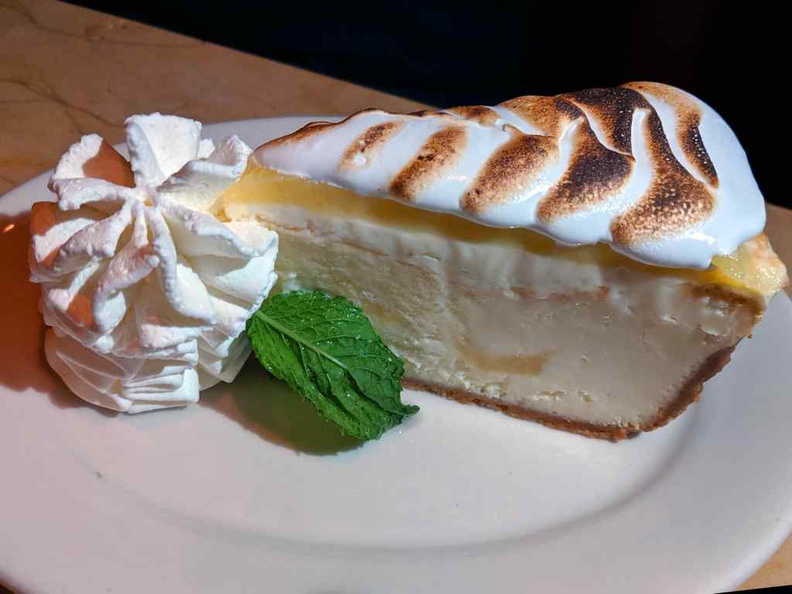 Lemon Meringue Cheesecake Topped with Layers of Lemon Mousse and Meringue