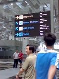 littered along the terminal are large multi-coloured, multi-lingual sign boards