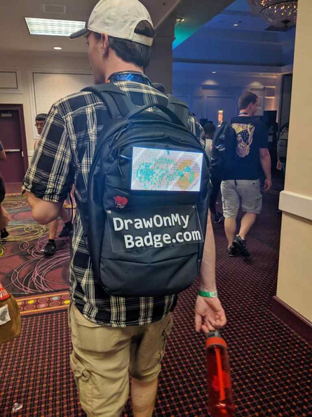 Plan your schedule in DEFCON to get the most out of the convention. There is alot happening at any time, like trying to draw on this guy's backpack