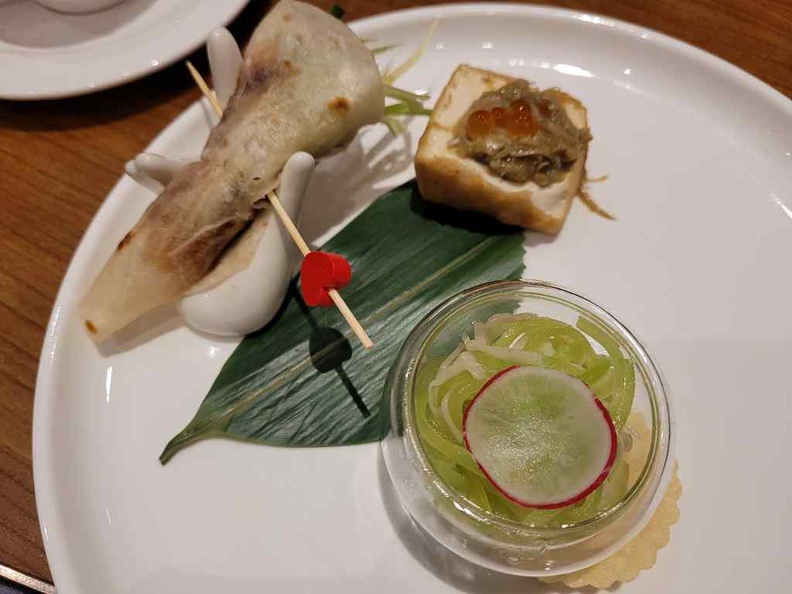 Huating Restaurant appetizer with Chilled Asparagus Lettuce, Enoki Mushroom, Truffle, stuffed bean curd, crab Roe, smoked duck and hand roll