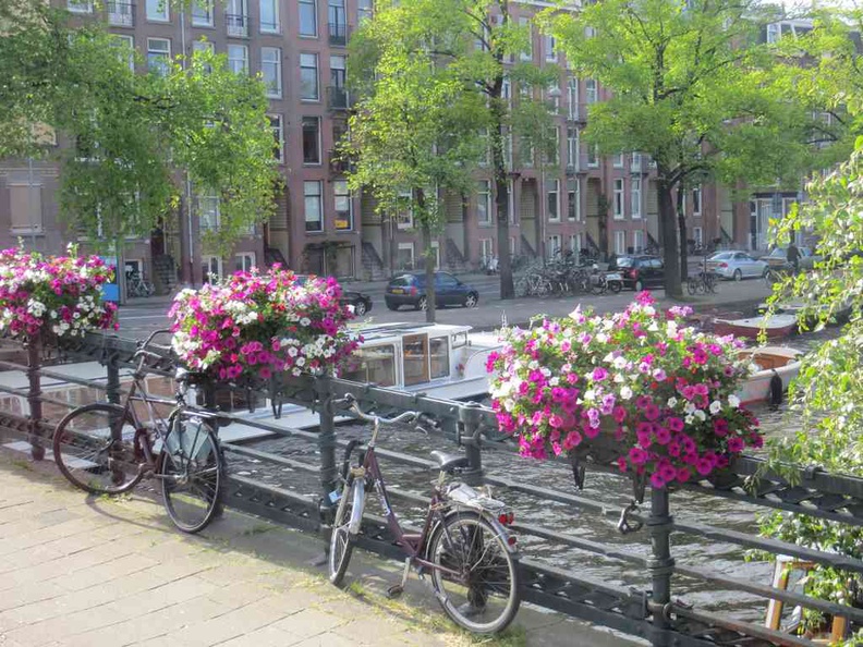 Bicycles parked over one of the main canal river bridges in the Amsterdam Netherlands city
