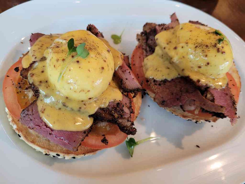 Delancey ($28)- hand-sliced beef pastrami, served with poached eggs, tomatoes & grain mustard Hollandaise on a sesame bagel