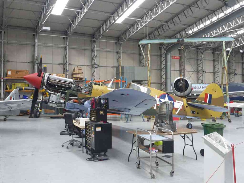 Interior working workshops housing a Spitfire plane under restoration
