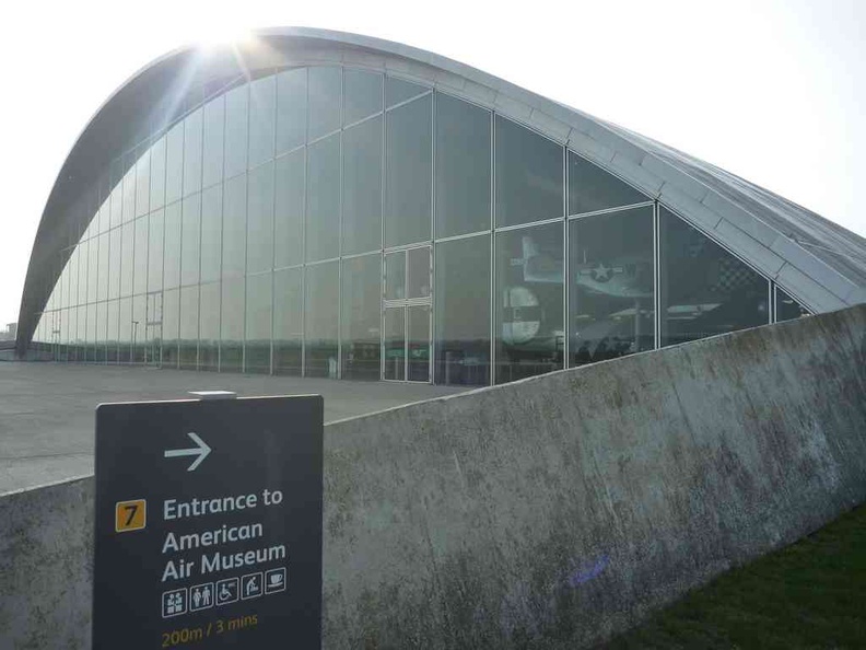 American air museum building structure, a modern looking hanger with a glass front