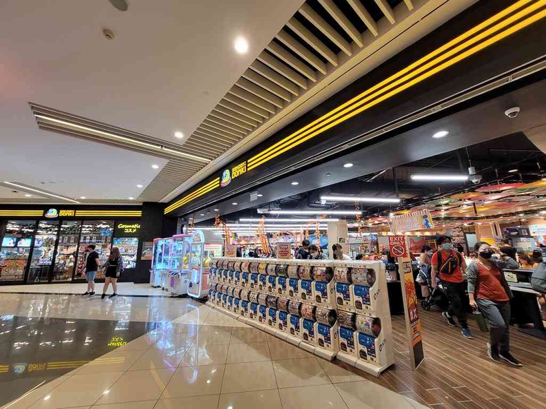 Row of Gashapon machines along the exterior of Don Don Donki Suntec store exit