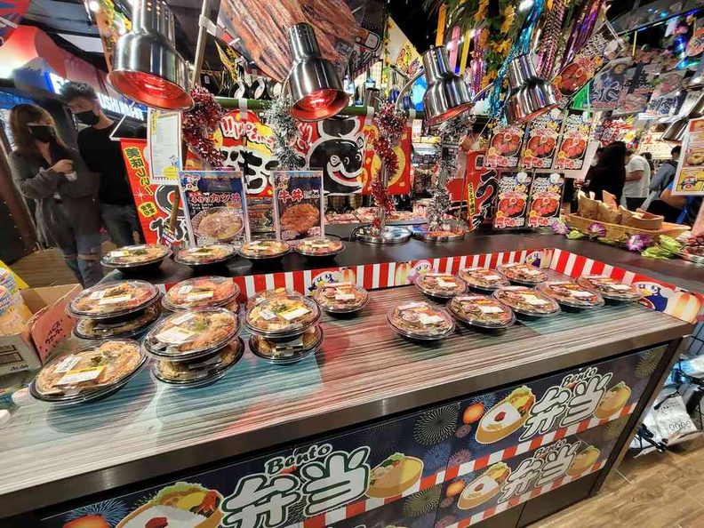 A huge selection of Bento sets, with sushi, large instant katsu bento meals, takoyaki, and interestingly ready-to-eat pizzas in-box sets