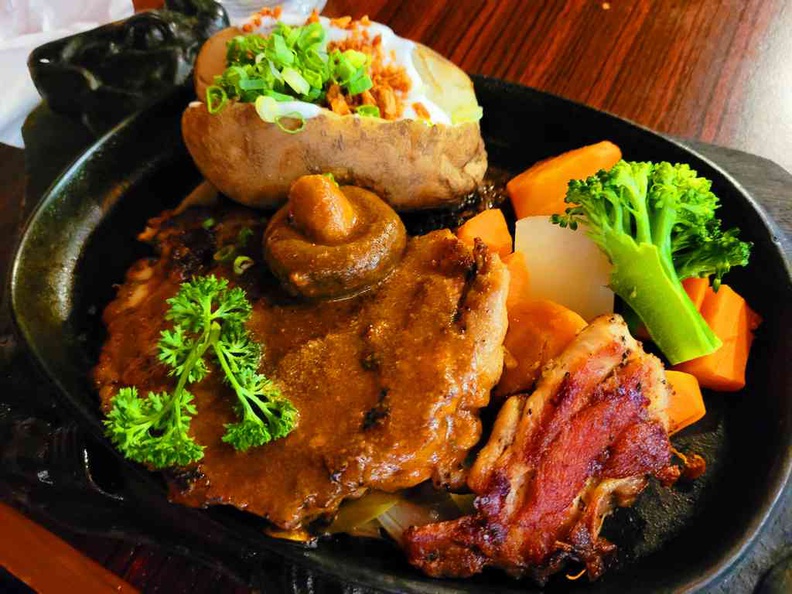Mariner's corner sunset way Crisp grilled Chicken chop with baked potatoes served on sizzling hot plate