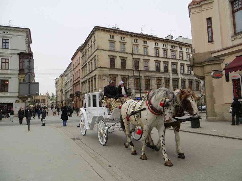  Krakow City streets with horse carriages in the Historical district in Krakow