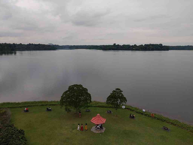 View of the Seletar reservoir with the small green clearing and hut by the water body