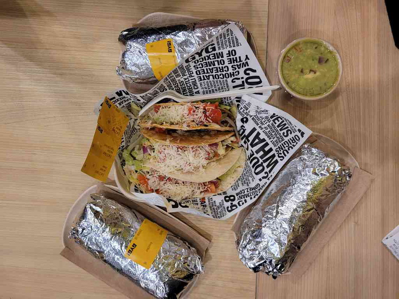 A Mexican burrito and tacos spread offering with obligatory guacamole