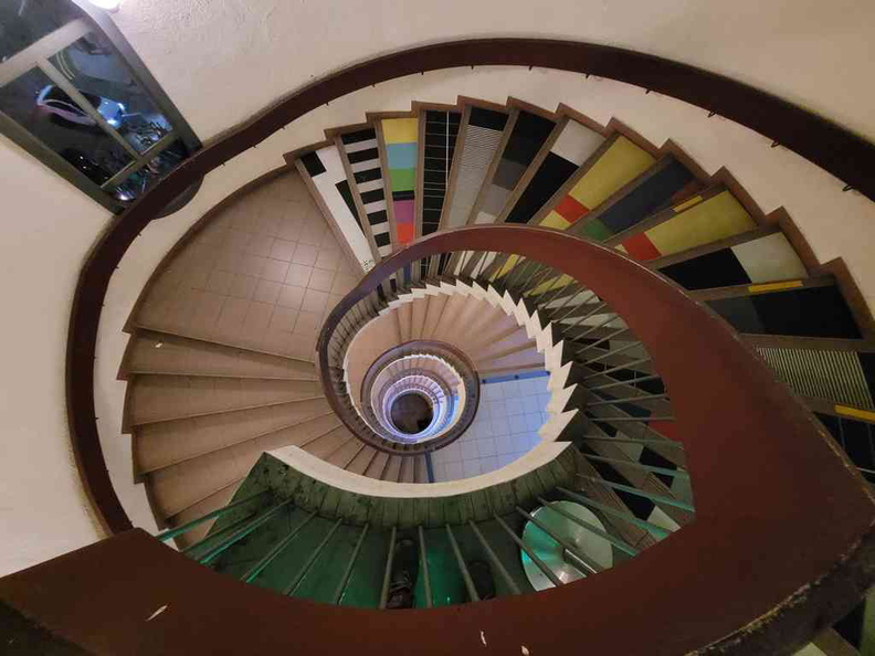 Looking down a spiral staircase at Golden Mile Tower Projector cinemas