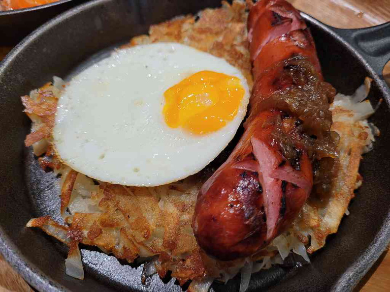 Wursthans large sausage main with Rosti and topped with fried egg