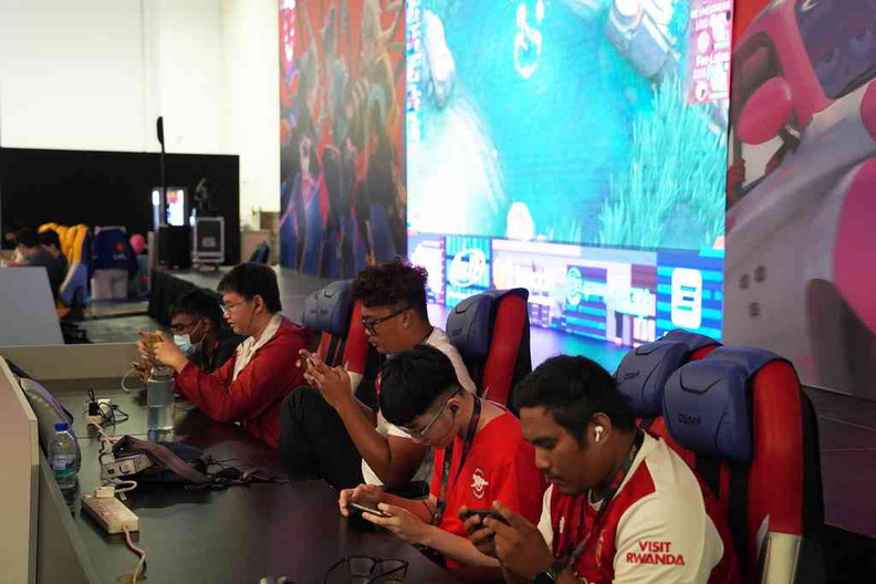 E-sports gaming stage with live mobile gaming matches on a big screen