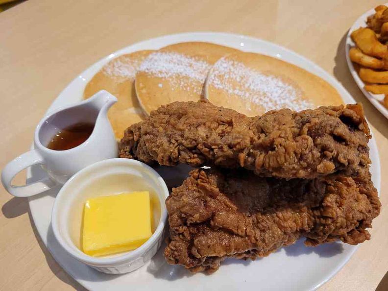 Breakfast offering with syrup pancakes and fried chicken to start your day