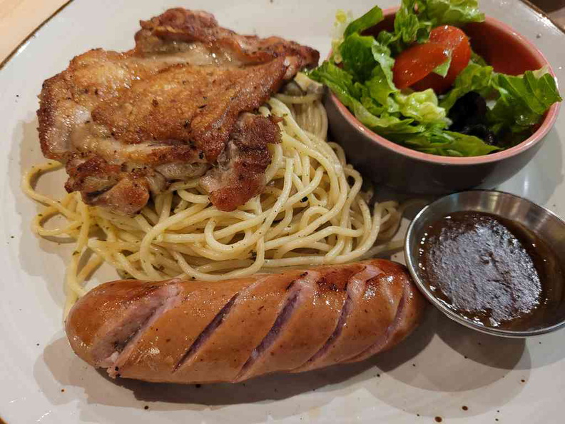 Chicken chop, served with spaghetti and salad greens with option for an additional sausage as a side