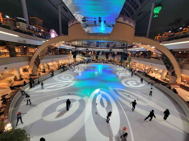 Ice skating rink all lit at night.