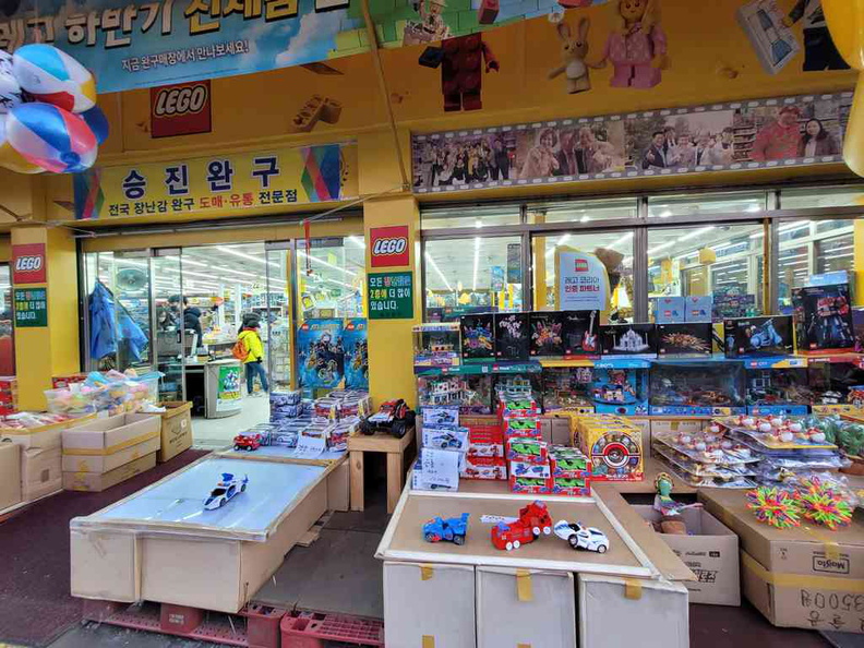Toy shops, hawking a diverse set of toys, though mostly focused on cheap plastic kiddy toys
