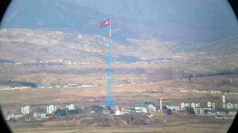 View of North Korea, with the DPRK propaganda village and flag in view from Dora Observatory