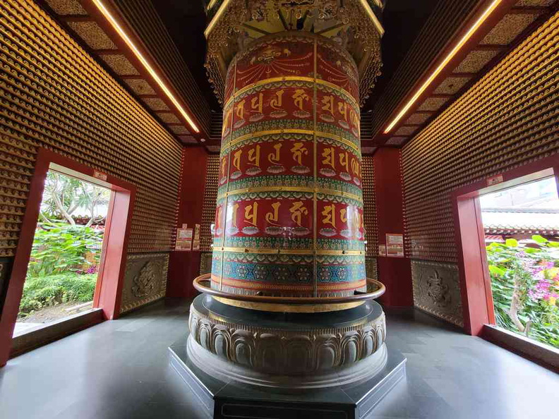 Rotating prayer wheel located in a hut on the top floor rooftop garden