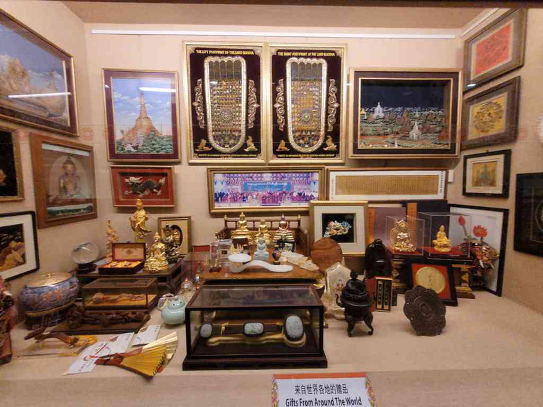 Trinkets gifted to the temple on display behind glass