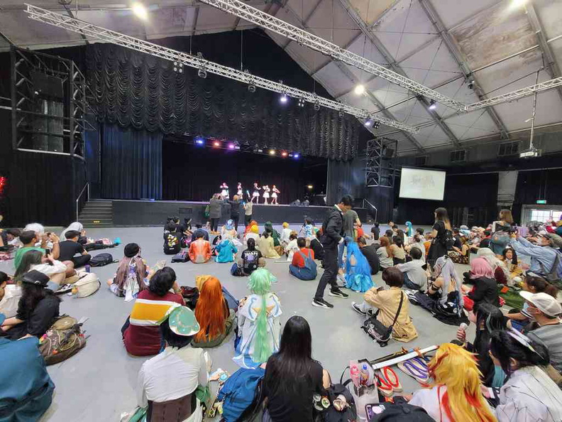 Dances engaging audience on stage.