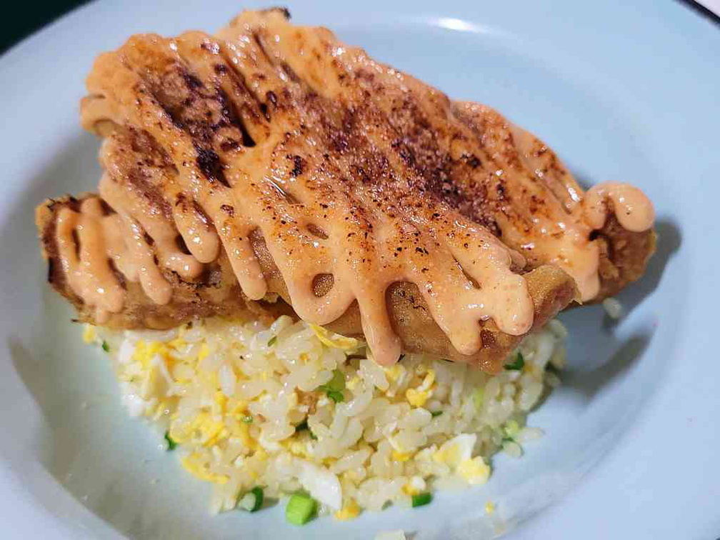 Mentaiko Fish Fried Rice ($13.90). Featuring crispy fish fillet laced with strips of mayo atop flavorful fried rice.