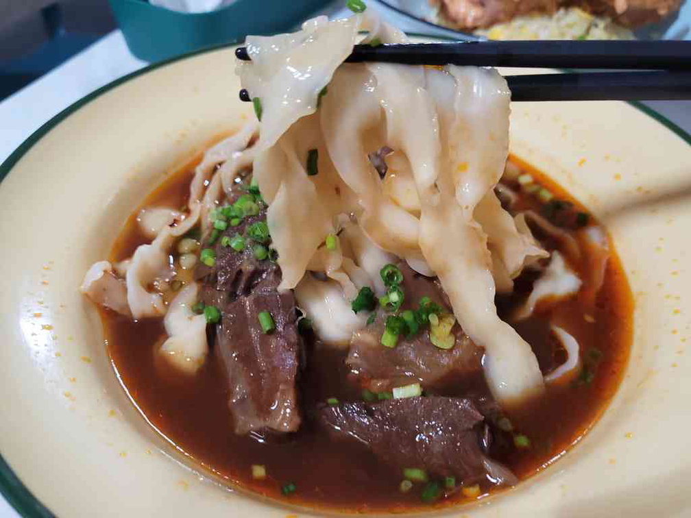 Fresh knife-cut flat “quay teow” shaped noodles which seemingly exhibits the consistency, texture and firmness of hand-pulled homemade noodles.