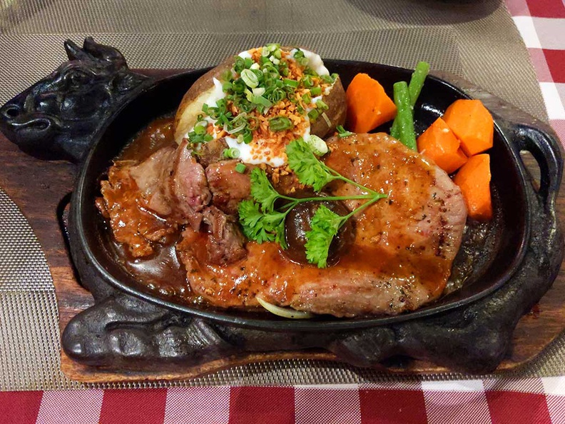 mariners corner cantoment sirloin steak, served on a nice classic sizzling hotplate with baked potato toppings.