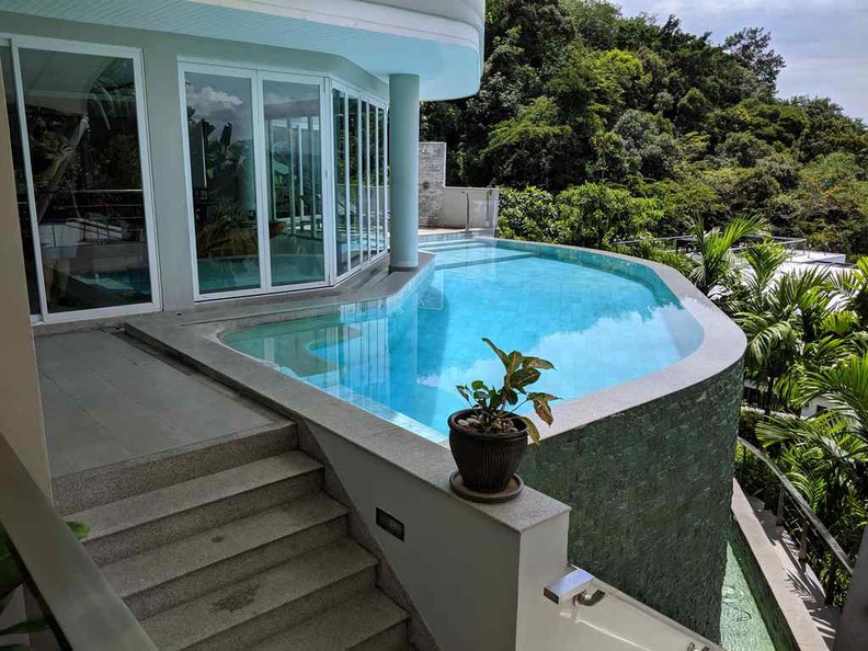 The infinity pool and overflow pond below at the living room floor. There are 2 more rooms below the living floor area accessible via stairs