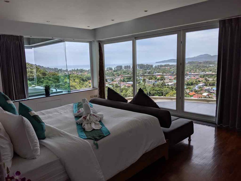 The main master bedroom with a balcony overlooking the distance bay and the infinity pool below