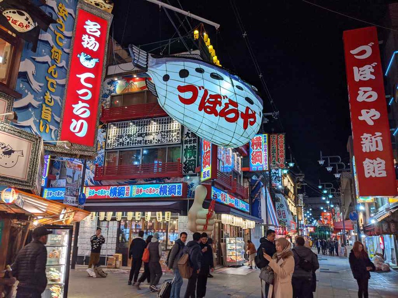 Shinsekai food district is buzzing, full of small discount stores, restaurants and takeaway eateries