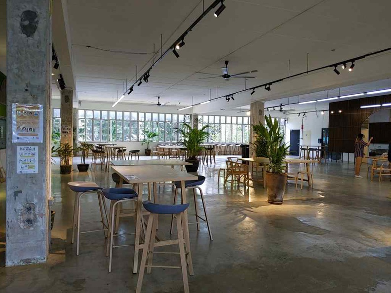 city sprouts sprout hub dining area comprises of a mix of tall and sit-down tables in a non-air-conditioned environment with lots of open ventilation.