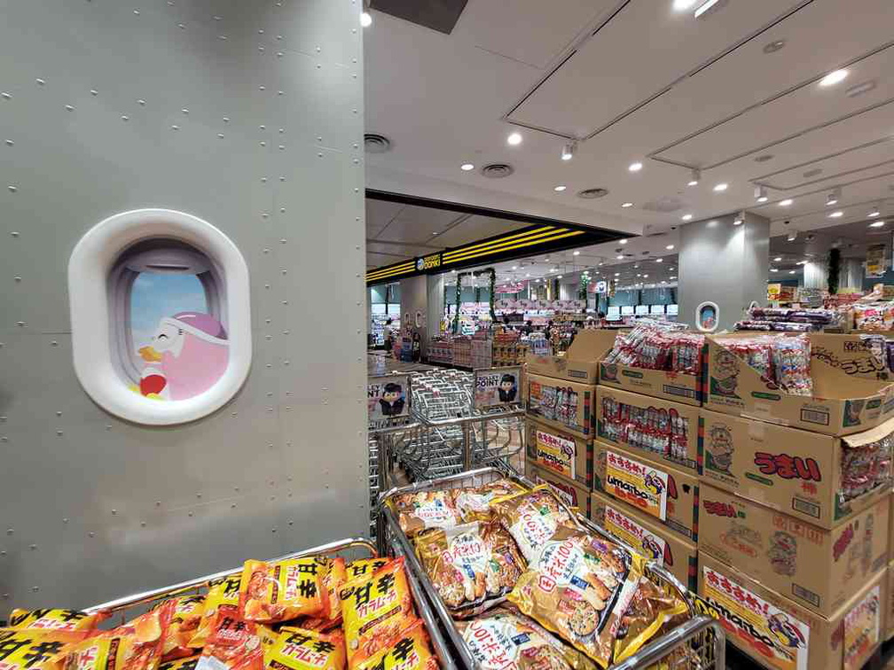 Airplane themed, with Donki's penguin mascot seen on airplane windows on the store pillars
