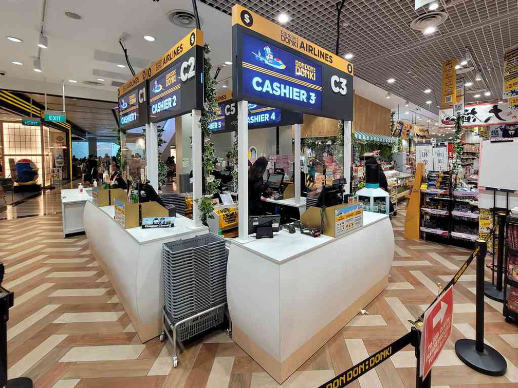 Well-themed airport counter style checkout counters. 