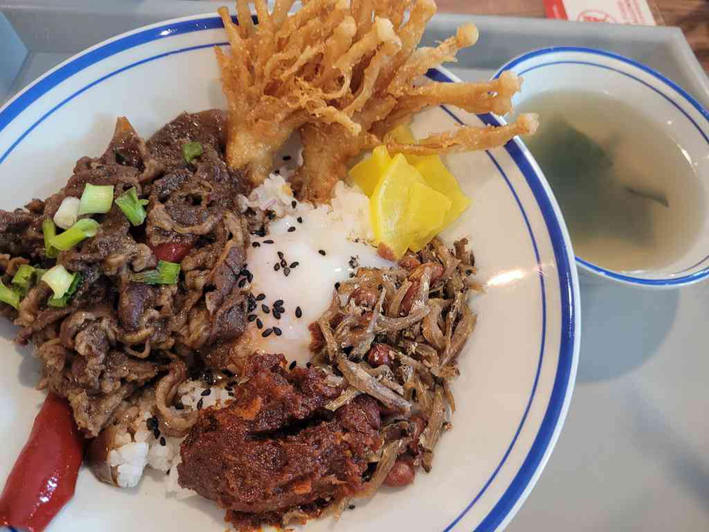 Served with sides of soup, Tempura Enoki Mushrooms, Daikon, and peanuts Ikan Billis